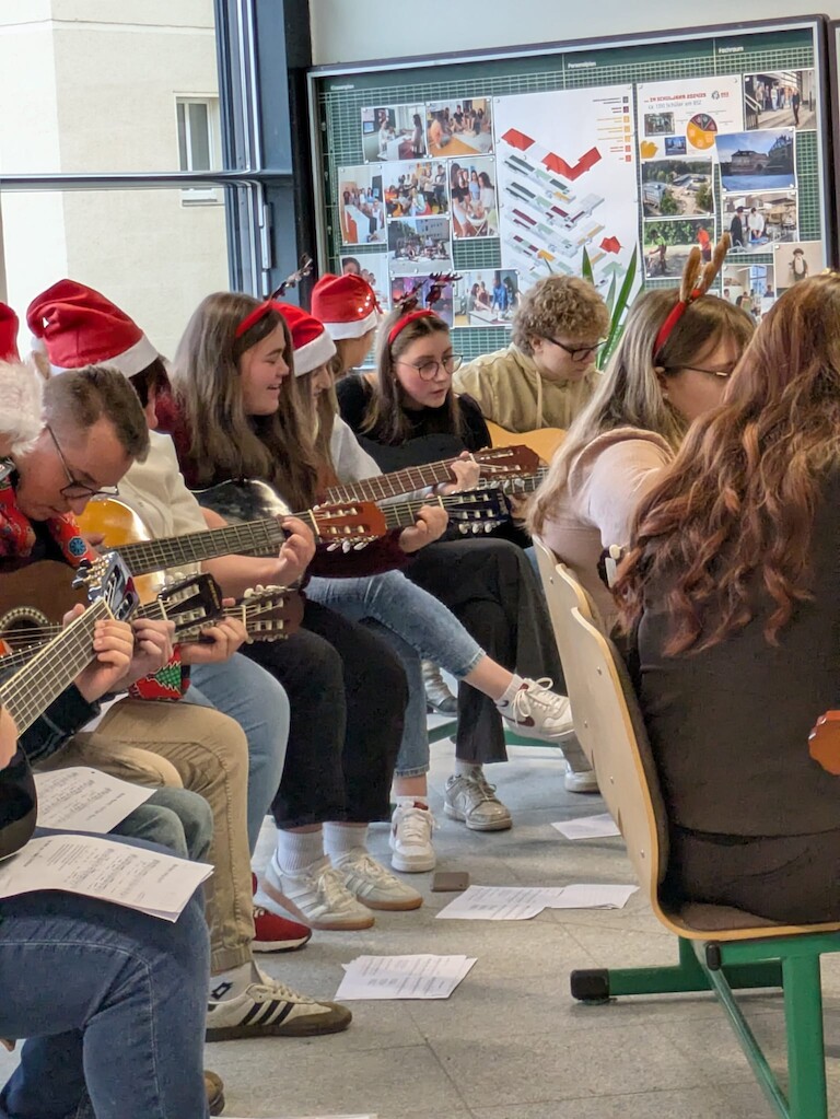 Die EZ Schülerinnen spielen auf ihren Gitarren.